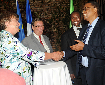 Rwanda National University Rector Prof. Silas Lwakabamba (R) shakes hands with the acting Chargeu00e9 du2019Affaires at the French Embassy iChantal Bes after signing the MoU. The New Times / John Mbanda.