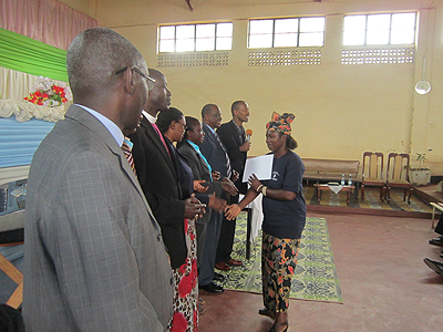 A volunteer receives her certificate on Tuesday. The New Times / JP Bucyensenge.