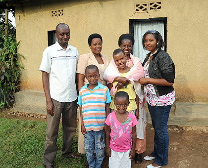 Florence Bayisenge (2nd right) holds her foster child in a photo with the rest of the family. The New Times / John Mbanda.