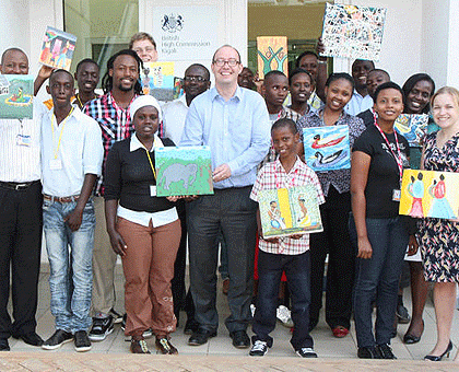 British High Commissioner to Rwanda, Ben Liewellyn-Jones Obe( C) pose in a group photo with students of Kimisange Secondary school. The Sunday Times / Courtesy.