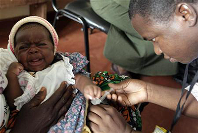 A child is given an injection as part of a malaria vaccine trial. Net photo.