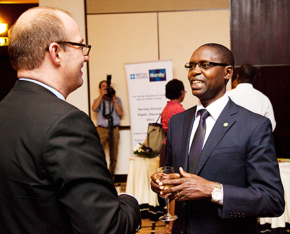 The British High Commissioner to Rwanda, Ben Liewellyn-Jones Obe (L), chats with State Minister Dr Mathias Harebamungu,at the launch on Wednesday. The New Times / T. Kisambira