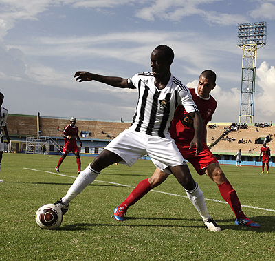 APR skiper Olivier Karekezi shields the ball from an Esperance Sportif de Tunis opponent in last year's Champions League clash in Kigali. The New Times / File.