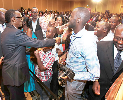 President Kagame greets participants at the Rwanda Day 2012 in Boston, United States, on Saturday. The New Times / Village Urugwiro.