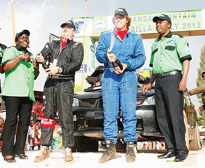 Olivier Costa and his navigator Didier Duquesne celebrating second place finish in the KCB Mt. Gorilla Rally yesterday. Photo / George Barya.