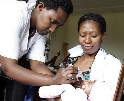 A health provider immunising an infant. US Secretary of State Hilary Clinton has applauded Rwanda's health sector. The New Times / File.