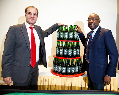 Jan van Velzen, Bralirwa's Sales and Marketing Director (L) and Elvis Olivier Castanou the Marketing Manager pose with the new Heineken bottles yesterday. The New Times  / Timothy Kisambira