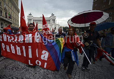 People hold banners during a public service workers demonstration in central Rome on September 28, against the government plans on financial cuts and spending review. AFP photo.