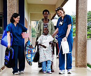 Seven-year-old Fidel Mihoza  one of the patients who underwent free open heart surgery at Kigali King Faisal Hospital last year, with his mother and medics who operated him a few months ago. More children will be operated this week. The New Times / File.