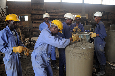 Workers at NPD- Cotraco in protective gear at work. The New Times / John Mbanda.