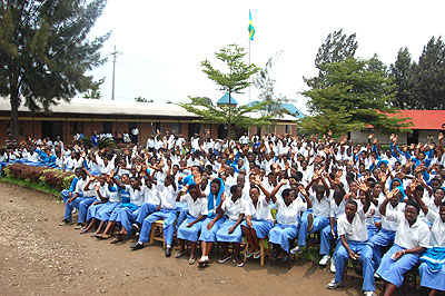 Students raise up their hands in support of girl child education. The New Times / S.Rwembeho.