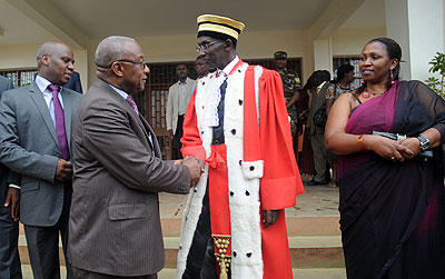  Chief Justice Prof. Sam Rugege (C) congratulates the new president of the National Electoral Commission Kalisa Mbanda, as his deputy Marie Odette Kansanga Ndahiro  (R)and Executive Secretary  Charles Munyaneza, look on after the swearing ceremony yesterd