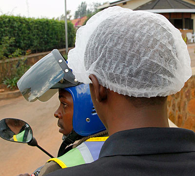 A passenger wearing a smart head cover. The New Times. File