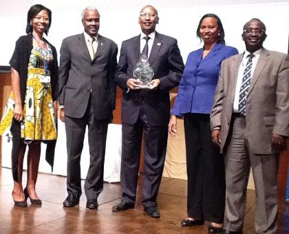 John Rwangombwa holding the Finance Minister of the Year trophy,. Next to him is Rwandau2019s Ambassador to Japan, Dr. Charles Muligande.  The Sunday Times /Courtesy.