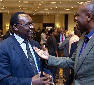 The Minister of Trade and Industry, Francois Kanimba( L) chatting with CEO of RwandaAir John Mirenge during the launch of the Rwanda Public Private Dialogue. The Sunday Times / T.Kisambira.