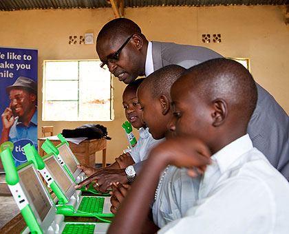 The State Minister in charge of Primary and Secondary Education, Mathias Harebamungu, chats with pupils of Kimisagara Primary school. The New Times / Timothy Kisambira