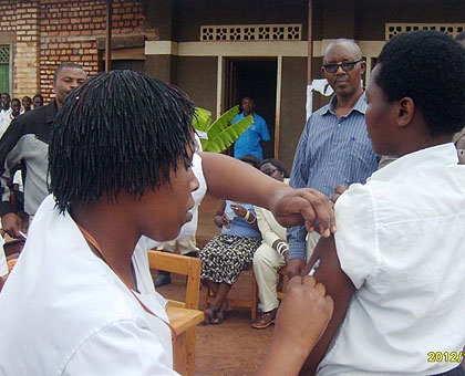 A nurse administers the Human papilloma Virus vaccine to a student at Groupe Scolaire Nkubi in Mukura sector on Tuesday. The New Times / JP Bucyensenge.