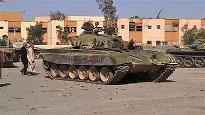 A damaged tank is seen after an attack by armed Gaddafi loyalists in Bani Walid, a town about 200 km (120 miles) from Tripoli early this year. Net photo.