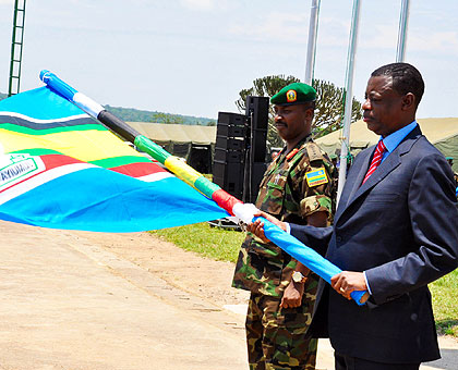 Defence minister James Kabarebe flags off the EAC Military Field Training Exercise at the Rwanda Military Academy-Gako as Chief of Defence Staff, Lt Gen Charles Kayonga, looks on. The New Times / Courtesy.