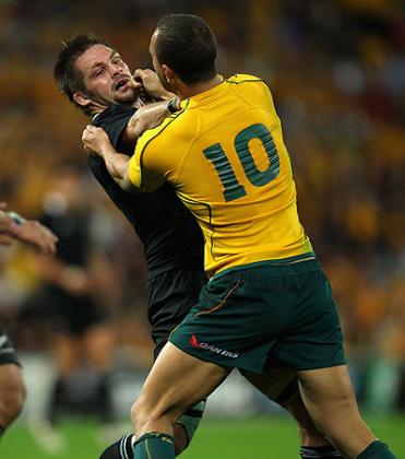 All Blacks captain Richie McCaw (lef) and Australia's Quade Cooper involved in a scrap in 2011. Net photo.