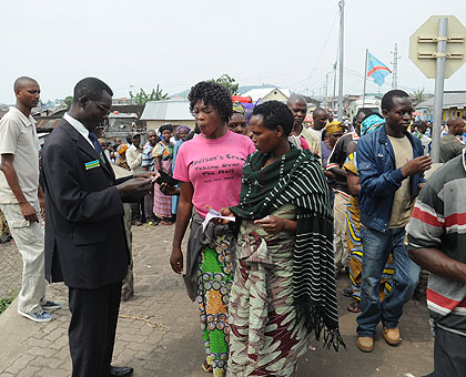 A Rwandan immigration officer clears people through the border. The cutting of working hours on the border has affected business. The New Times / File.