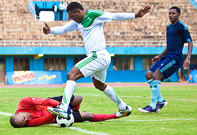 SC Kiyovu's veteran striker Bokota Labama is thwarted by Police custodian Alex Ganza on Wednesday. The New Times / T. Kisambira.