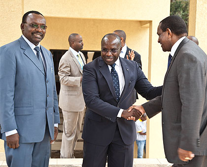 Prime Minister Pierre Damien Habumuremyi (C) shakes hands with Joseph Nyagah the outgoing chair and minister of Cooperative Development and Marketing, Kenya, as Minister of Trade and Industry, Franu00e7ois Kanimba, looks on. The New Times / T.Kisambira.