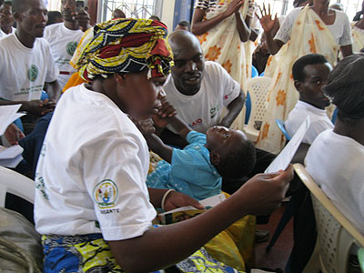 A woman, who completed a six month literacy programme, reads through her certificate. The New Times / JP Bucyensenge.