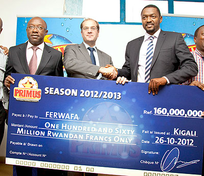 Jan van Velzen, Bralirwau2019s Director of Sales and Marketing shakes hand with Ferwafau2019s vice president Raoul Gisanura after signing the extension of the league sponsorship yesterday at Ferwafa headquarters. The New Times / T. Kisambira.