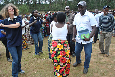 The World Bank team dances with the farmers. The New Times / Courtesy.