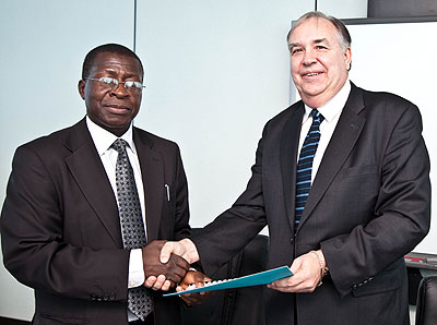 Hodge Semakula CEO EACO( L) with Jose M. Toscano the CEO of ITSO  after the signing at the EACO headquarters in Kigali yesterday . The New Times / T.Kisambira.