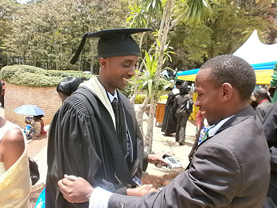 A guest congratulates a graduate after last Tuesday's ceremonies.  The New Times / JP Bucyensenge