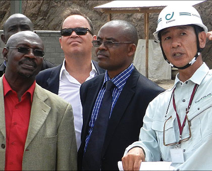 Engineer Hitoshi Kameda (R), explaining to EALA MP Abdul Karim Harerimana (L) and other officials on the progress of the construction of the OSBP at Rusumo border. The New Times / S Rwembeho.