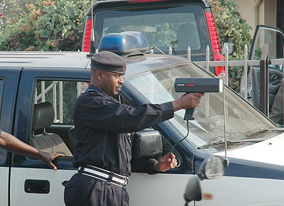 A traffic officer  with a speed gun. Police believes the equipment  has played a vital role in the reduction of accidents. The New Times / File.