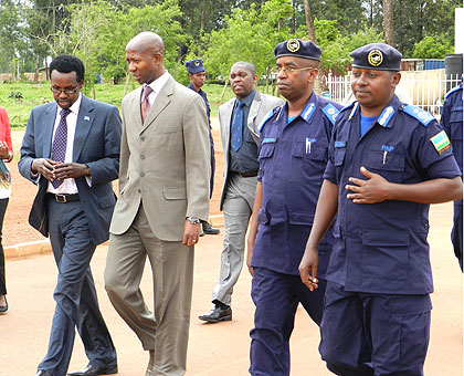 Somalis Ambassador to Rwanda, Cabdullani Sheikh Maxamed (L), Minister Musa Fazil Harerimana (2nd L), with some police officers at Gishari Police Training School yesterday. The New Times / S. Rwembeho.