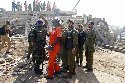 A member of the Israeli forces , right, liaise with local authorities as they assist in the Ghana relief efforts to find survivors, after a building collapsed in Accra. Net photo.