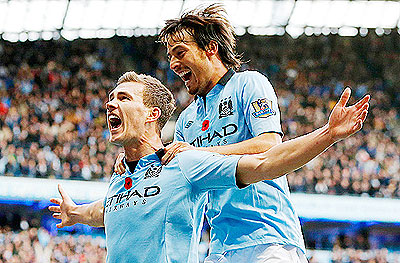 Edin Dzeko (left) and Manc City sit 2 points behind Man United with an unbeaten home EPL record of 35 matches. Net photo.