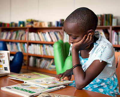 A child reading a textbook at Kigali Public Library. The New Times / T.Kisambira.