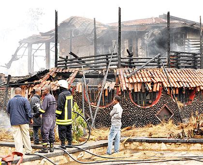 A man looks at the burnt Cadillac club early yesterday. The Sunday Times / Timothy Kisambira.