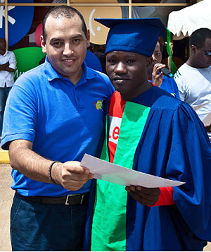 Tigo CEO Diego Camberos handing over a certificate to one of the graduates. The New Times / T. Kisambira.