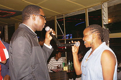 James Onyango and Caroline Nderitu lead the Karaoke Night. The New Times/Andrew Israel Kazibwe.