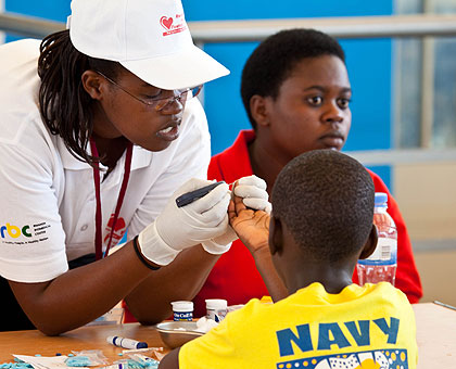 A patient testing for Diabetes at Petit Stade. The New Times / T.Kisambira.