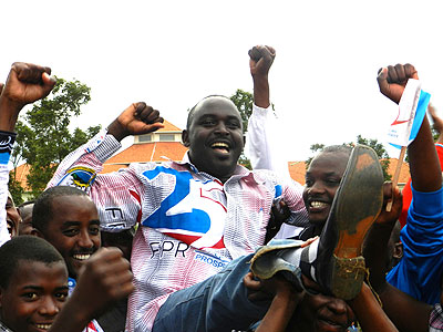 Youth lift high Louis Rwagaju, the Mayor of Bugesera, district after his district emerged the overall winner. The New Times / S Rwembeho.