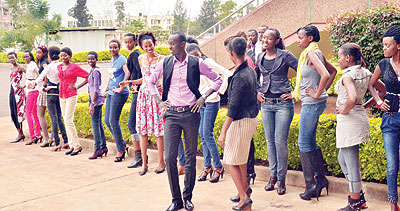 Jean Claude Ndayishimiye (C) trains aspiring models how to strike a pose.