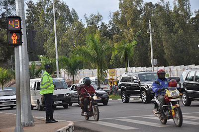 A traffic police officer monitoring traffic on a Kigali street. 