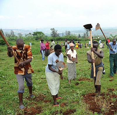 People tilling land. The New Times / File.