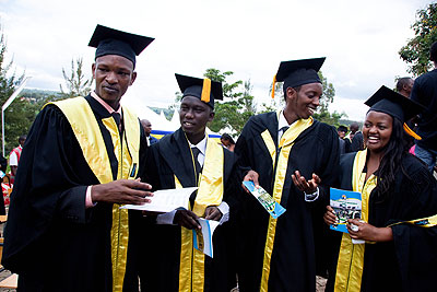 Richard Ruhimbana, a journalist with Izuba Rirashe newspaper (L), and other graduands share a light moment after being conferred with Bachelor degrees. The New Times / T.Kisambira.