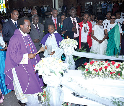 A priest conducts prayers at the church. All photos/Plaisir Muzogeye.