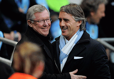 Man United Manager Sir Alex Ferguson shakes hands with Man City's Roberto Mancini (R) prior to last season's clash at Etihad Stadium. Net photo.