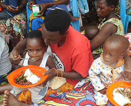 Children being fed on beans during a nutrition campaign. The Sunday Times / J. Mbanda.